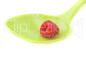 Raspberries in a spoon isolated on white