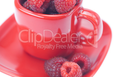 raspberry, saucer and cup is isolated on a white