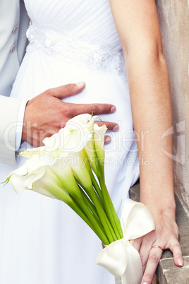 the bride and groom with a bouquet of flowers