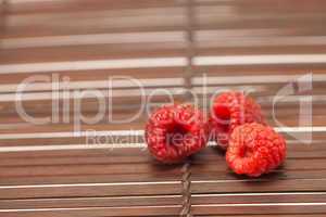 Raspberries on a bamboo mat