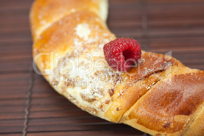 Roll with raspberries on a bamboo mat