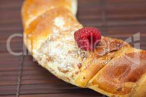 Roll with raspberries on a bamboo mat