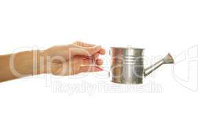 Woman hand with a steel watering can