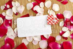 Card and rose petals