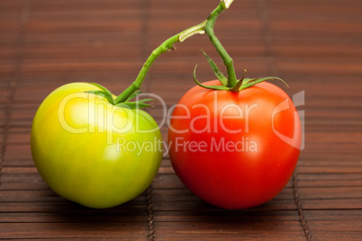 red and green tomatoes on a bamboo mat