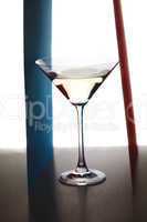 martini glass and colored paper on a white background