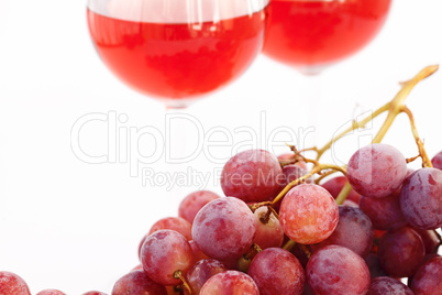 glass of wine and a bunch of grapes isolated on white