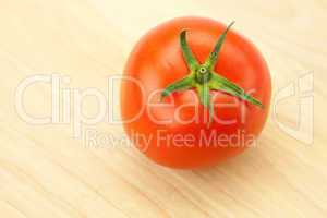red tomatoes on a cutting board
