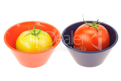 green and red tomatoes in a bowl isolated on white