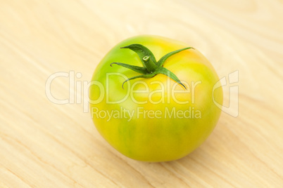 green tomatoes on a cutting board