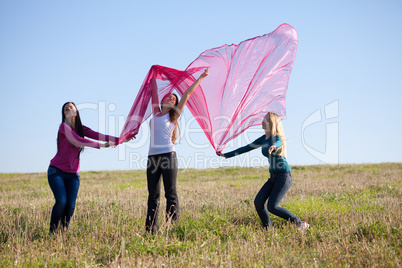 beautiful teenager woman jumping with a thin tissue outdoor