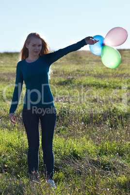 beautiful teenager  woman with a balloons outdoors