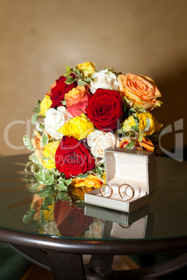 Bridal bouquet and a ring on the table