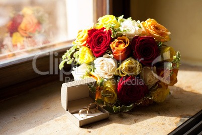 Bridal bouquet and a ring lying on the windowsill
