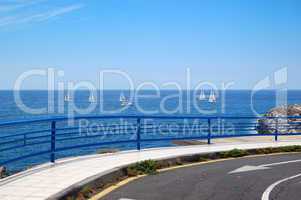 Road and fence with a view on Atlantic Ocean, Tenerife island, S
