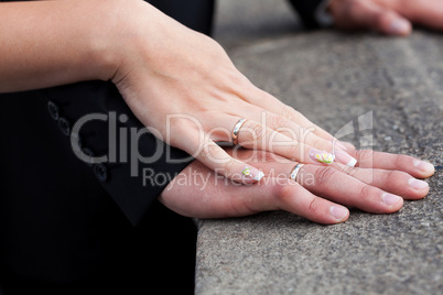 hands of the bride and groom with the rings