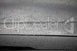 water droplets on the hood of a car