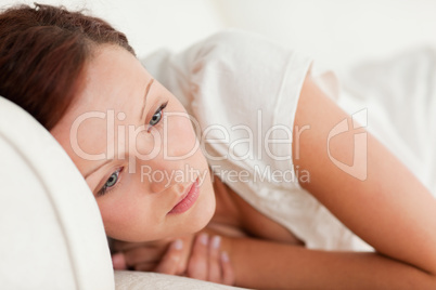 Sad woman lying on a bed