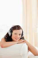 Close up of a dark-haired young woman listening to music