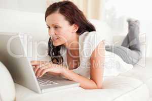 Relaxed red-haired woman searching the internet