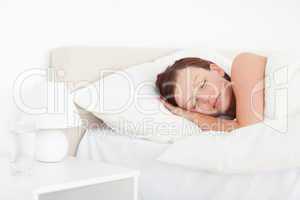 Beautiful Red-haired woman sleeping in bed