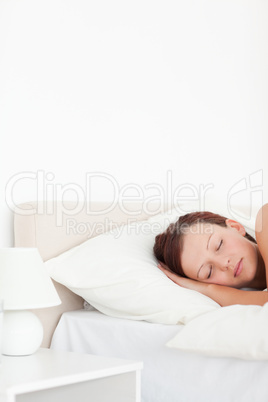 Close up of a Beautiful Red-haired woman sleeping in bed
