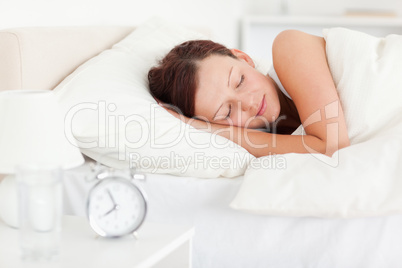 Red-haired woman lying in bed