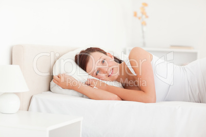 Relaxing beautiful woman lying on a bed