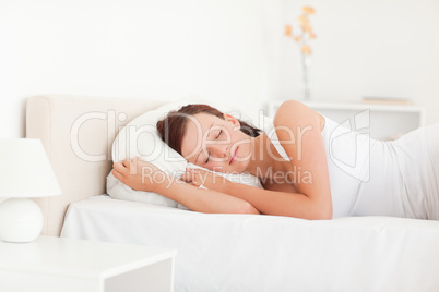 Sleeping beautiful woman lying on a bed