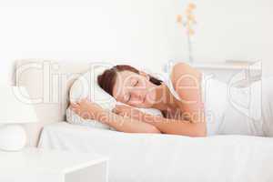 Sleeping beautiful woman lying on a bed