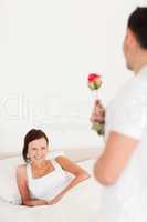 Handsome guy with a rose and his girlfriend