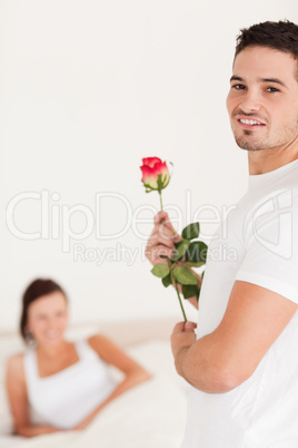 Guy with a rose looking into the camera