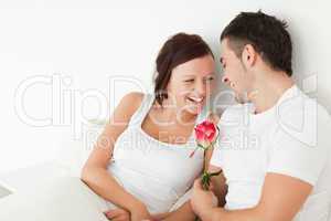 Cheerful couple with a rose