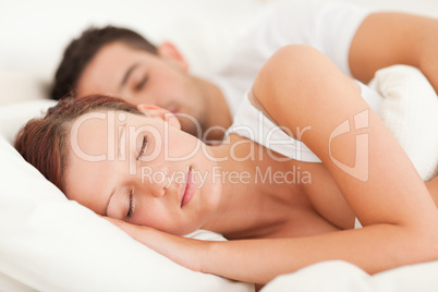 Sleeping couple lying in their bed