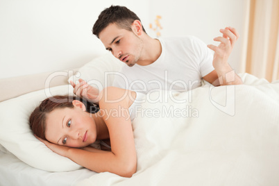 Unhappy couple in their bed