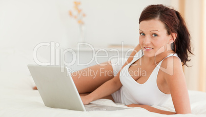Woman with a laptop looking into the camera Woman with a laptop looking into the camera