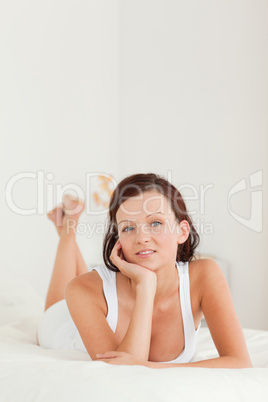 Cute Relaxed woman on her bed looking at the camera