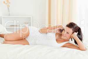 Charming Woman phoning on a bed