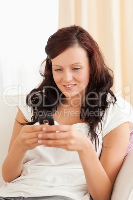 Charming Woman texting on a sofa