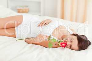 Woman with a rose having eyes closed