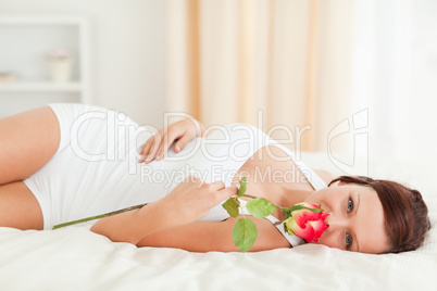 Woman with a rose looking into the camera