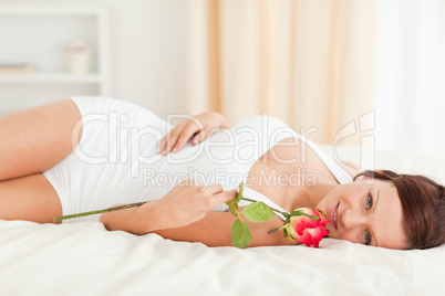 Young Woman with a rose looking into camera