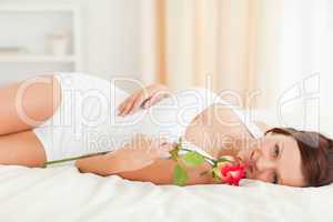 Young Woman with a rose looking into camera