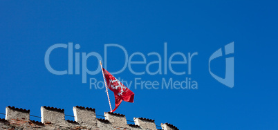 red flag of the fortress against the blue sky