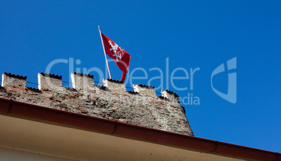 red flag of the fortress against the blue sky