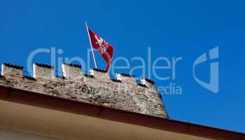 red flag of the fortress against the blue sky