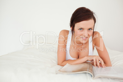 Woman with a magazine looking into the camera