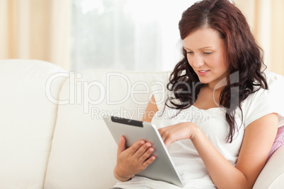 woman with a tablet on a sofa
