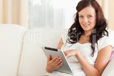 Woman with a tablet looking at the camera
