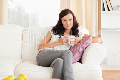 Smiling woman holding a cup
